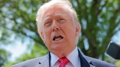 Donald Trump speaks to reporters outside the White House