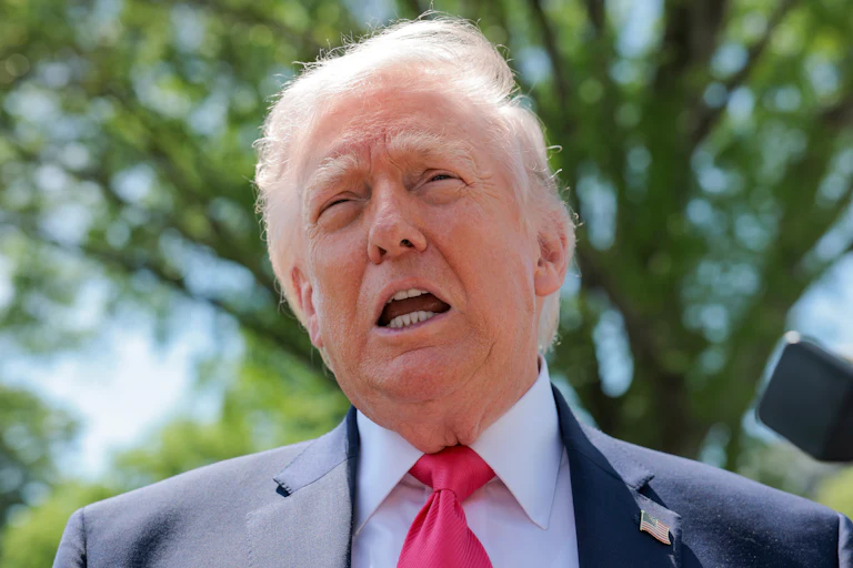 Donald Trump speaks to reporters outside the White House