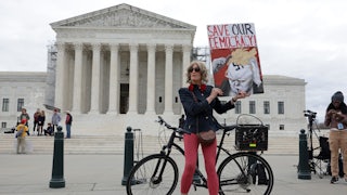 Local resident Nicky Sundt holds a sign that read “Save Our Democracy” in front of the Supreme Court, which unanimously ruled to keep former U.S. President Donald Trump on the Colorado ballot.