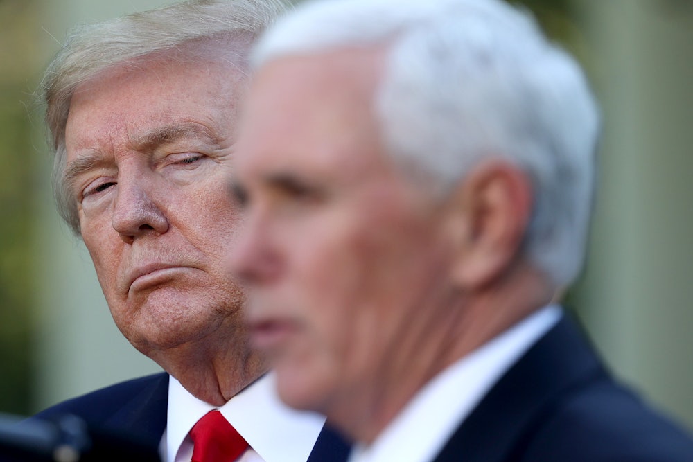 Mike Pence's blurry head appears in the foreground as President Donald Trump looks on from behind.