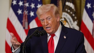 Donald Trump speaks into a microphone.