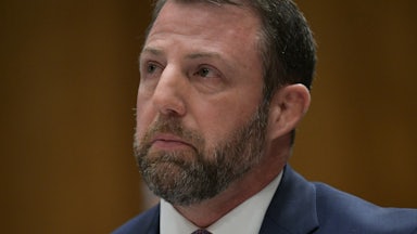 Senator Markwayne Mullin looks up while sitting in his Senate committee confirmation hearing for Homeland Security secretary.