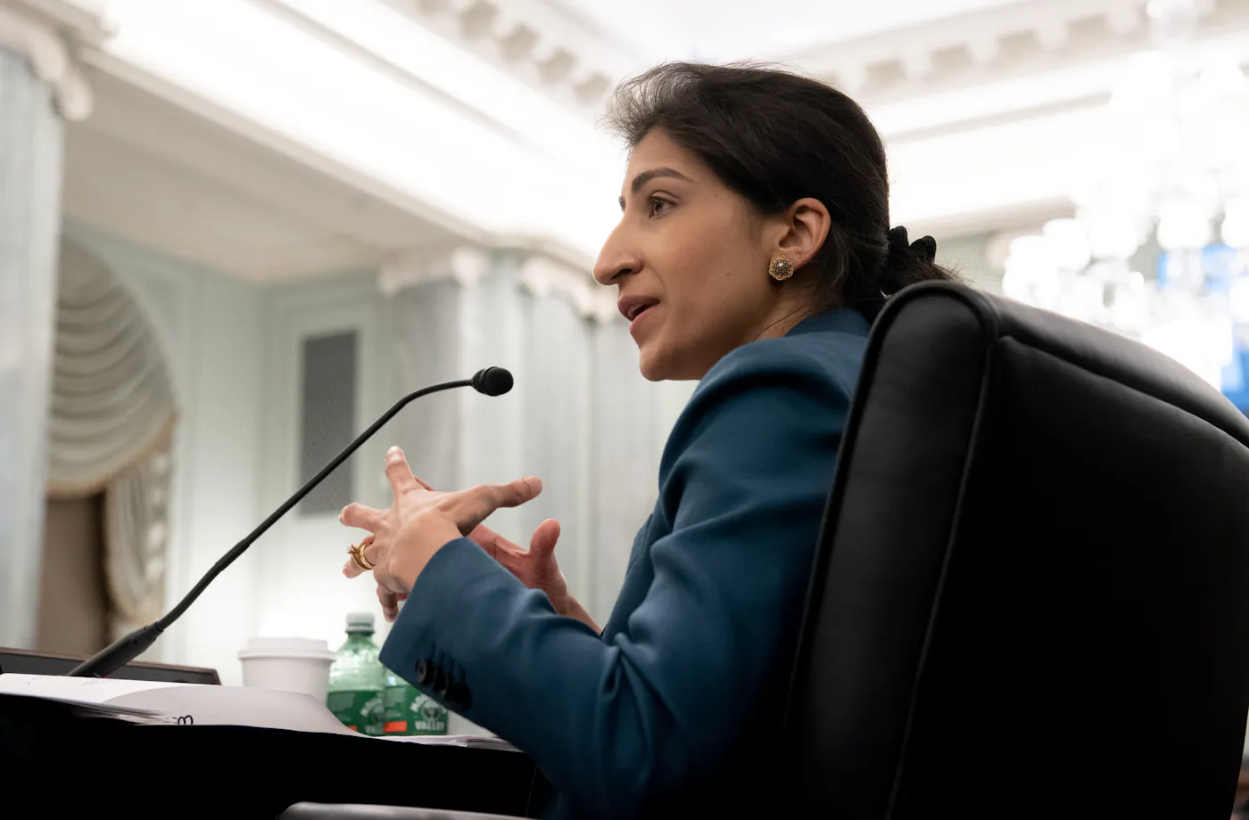 A photograph of Lina Khan as Federal Trade Commission. Her 2021 nomination and rise of antitrust enforcer chair provoked furious lobbying by Amazon and Meta against the nomination and was one of the signal events of tech’s descent into unambiguous villainy.