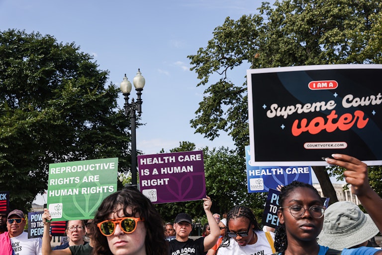 People hold up pro-abortion rights signs