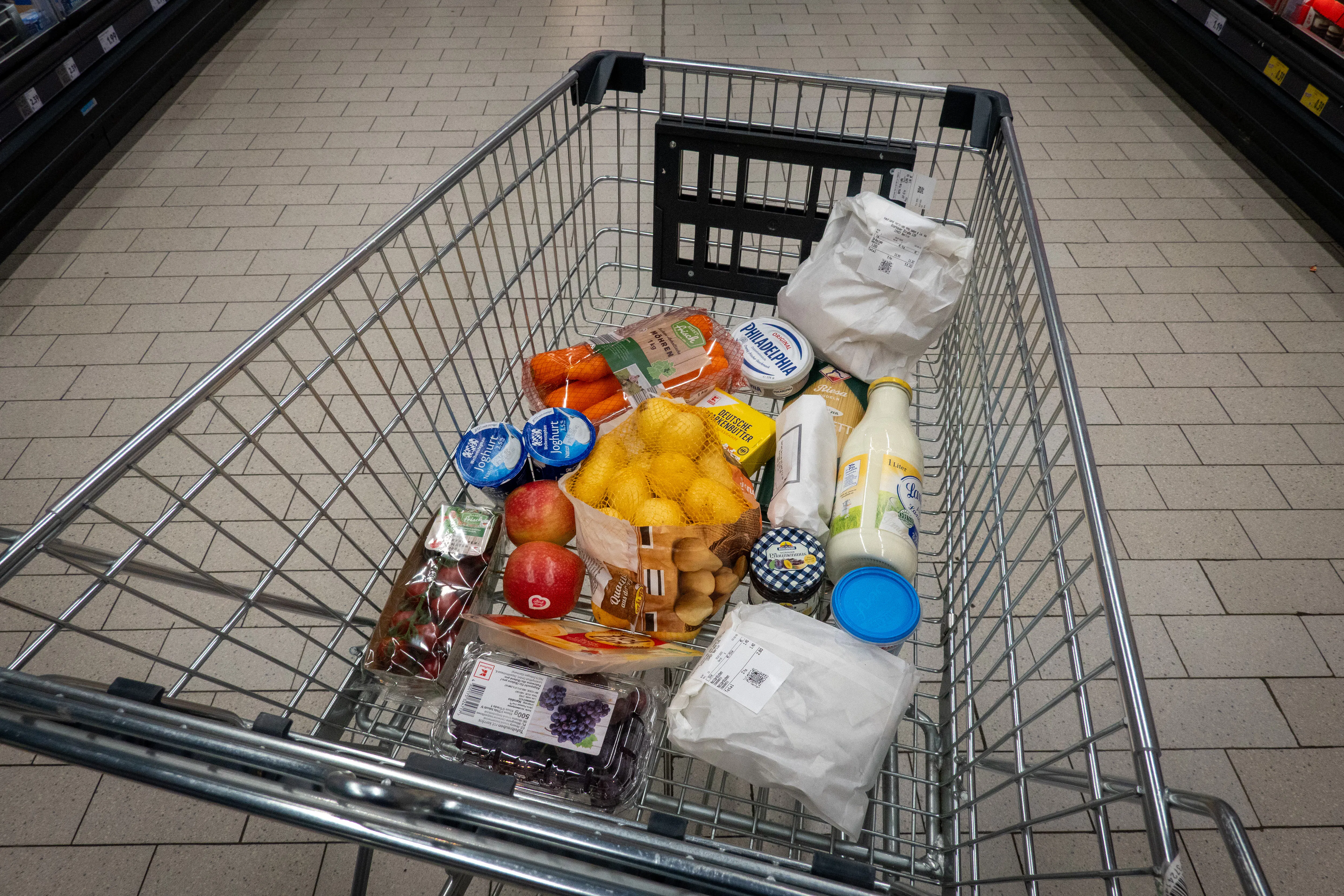 Grocery cart with potatoes, cream cheese, carrots, and more