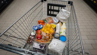 Grocery cart with potatoes, cream cheese, carrots, and more