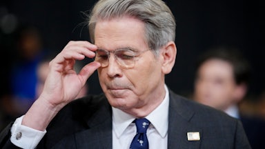 Treasury Secretary Scott Bessent readjusts his glasses while testifying in Congress.
