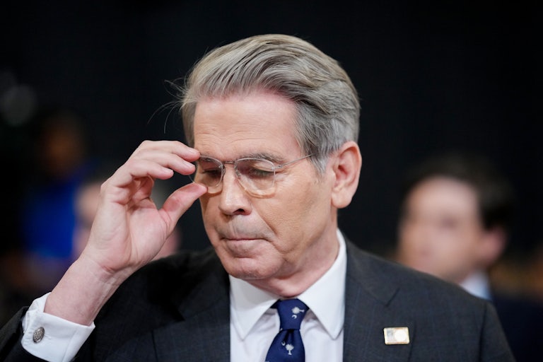 Treasury Secretary Scott Bessent readjusts his glasses while testifying in Congress.