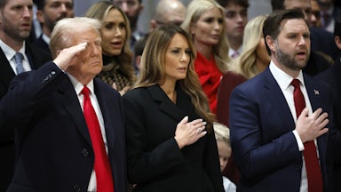 Donald Trump salutes while standing next to Melania Trump and JD Vance at the Washington National Cathedral
