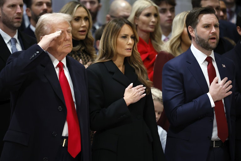 Donald Trump salutes while standing next to Melania Trump and JD Vance at the Washington National Cathedral
