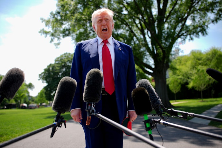 Donald Trump yells in front of a bunch of mics.