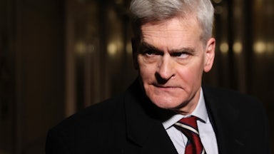 Louisiana Senator Bill Cassidy glowers in a dark hallway.