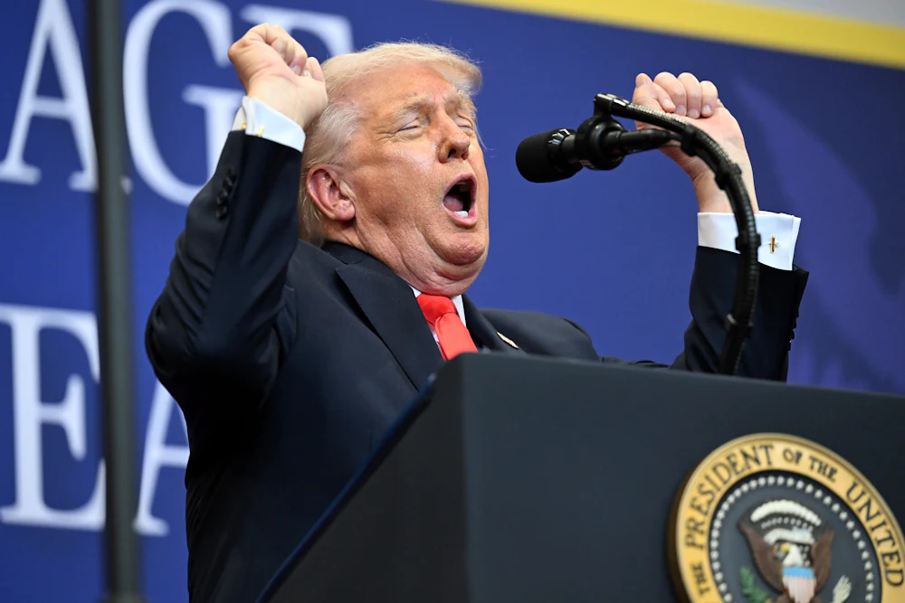 Donald Trump holds up both fists in awkward celebratory gesture
