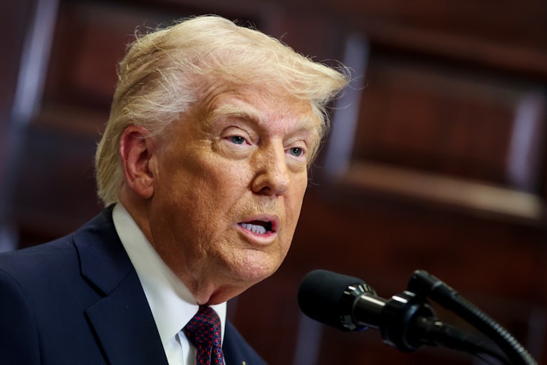 Donald Trump speaks into a microphone