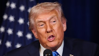 Donald Trump speaks into a microphone