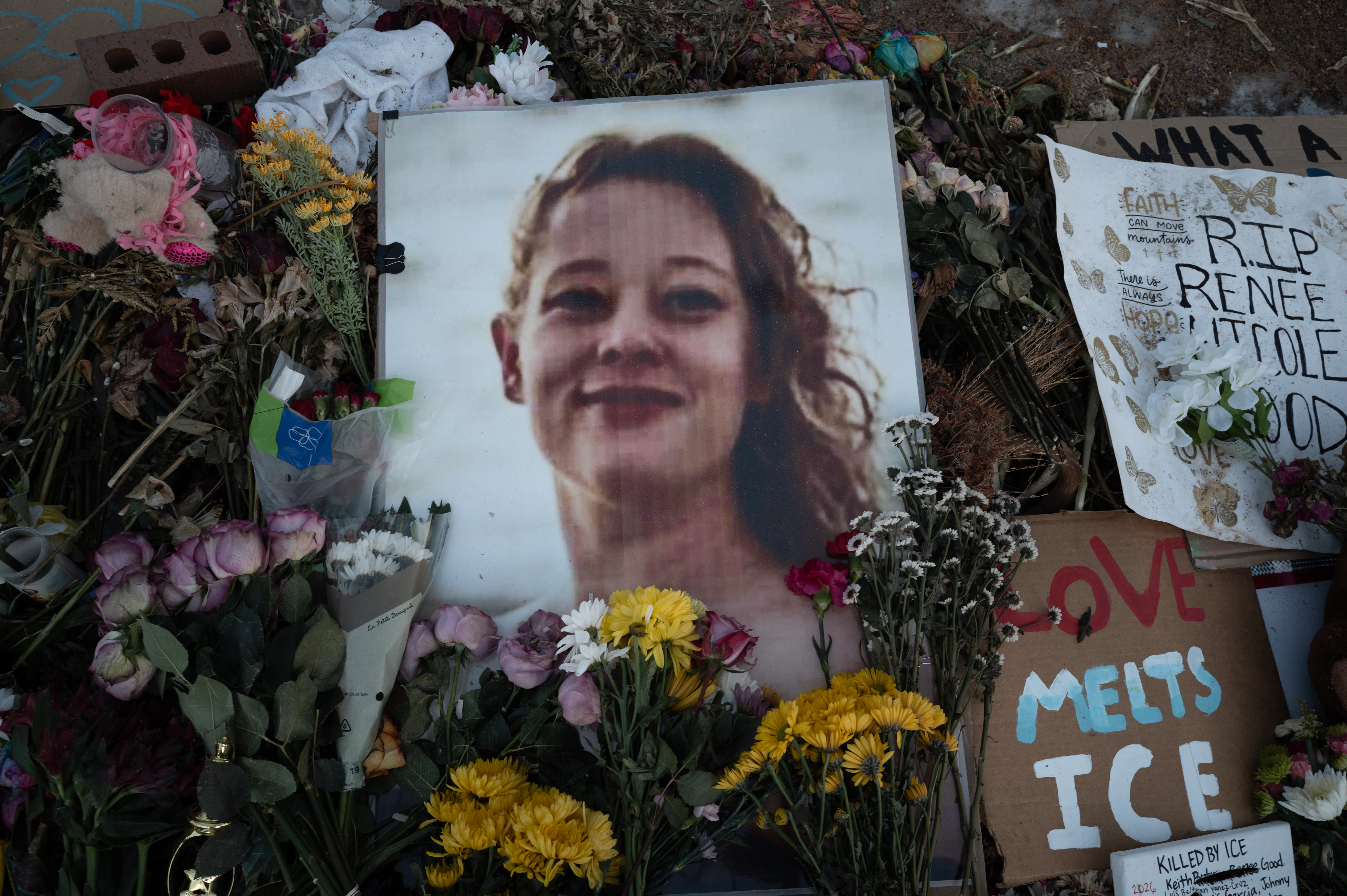 Renee Good vigil (candles and flowers alongside her photo)