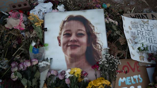 Renee Good vigil (candles and flowers alongside her photo)