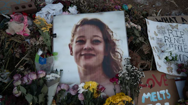Renee Good vigil (candles and flowers alongside her photo)