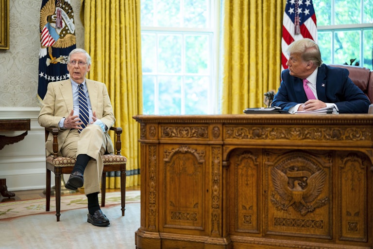 Mitch McConnell and Donald Trump sit in the Oval Office