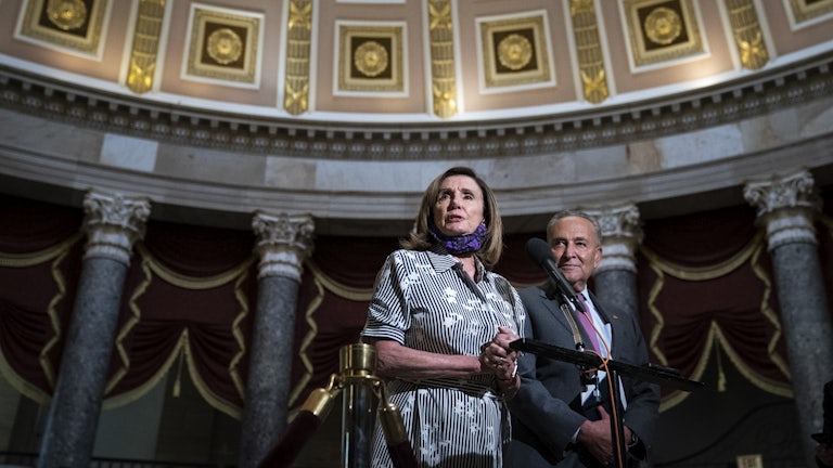 Chuck Schumer and Nancy Pelosi stand together in Statuary Hall in the U.S. Capitol.