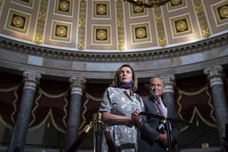 Chuck Schumer and Nancy Pelosi stand together in Statuary Hall in the U.S. Capitol.