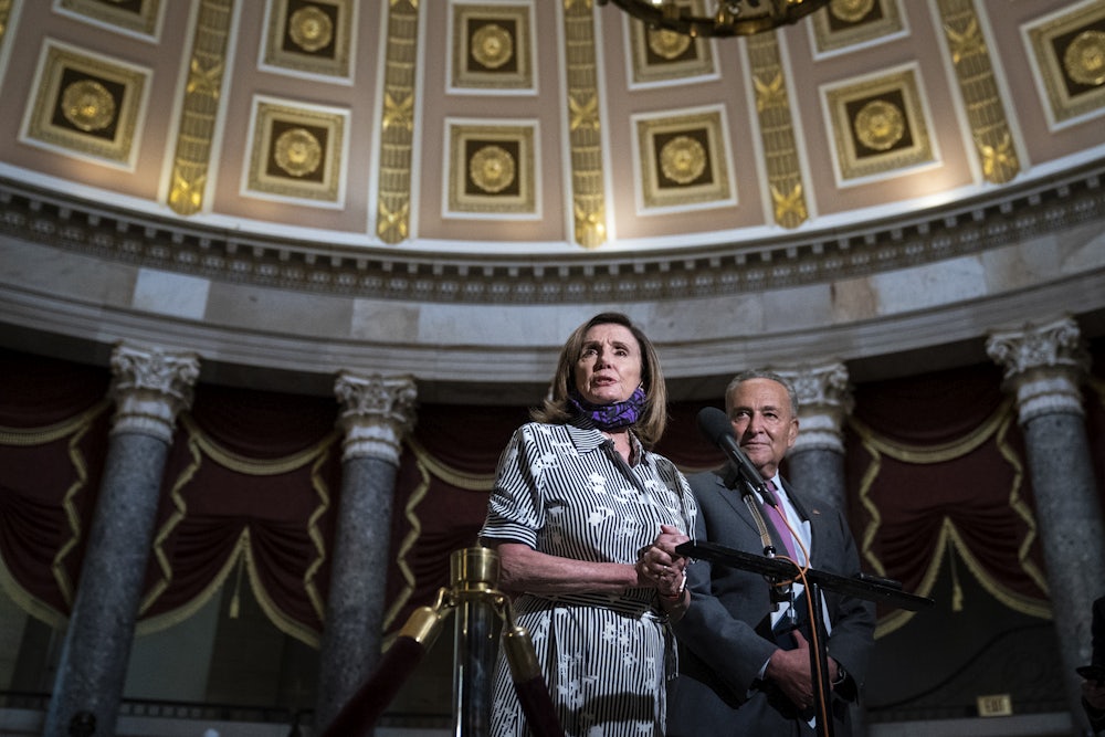 Chuck Schumer and Nancy Pelosi stand together in Statuary Hall in the U.S. Capitol.
