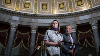 Chuck Schumer and Nancy Pelosi stand together in Statuary Hall in the U.S. Capitol.
