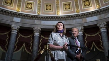 Chuck Schumer and Nancy Pelosi stand together in Statuary Hall in the U.S. Capitol.