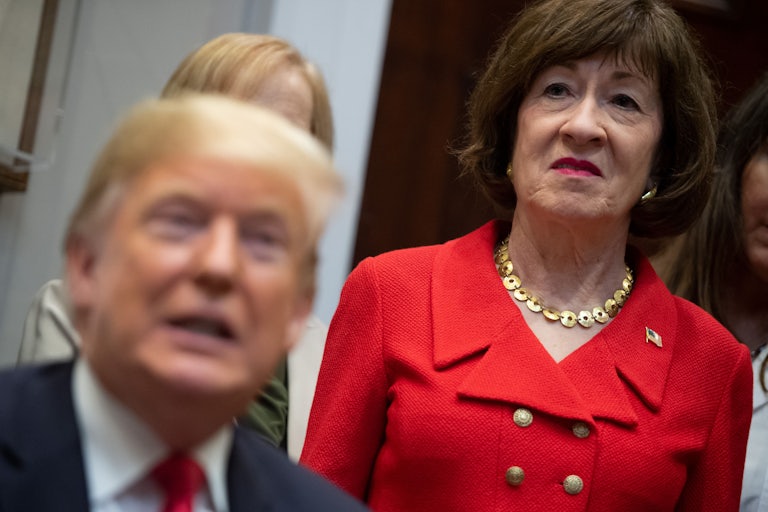 Senator Susan Collins behind President Trump