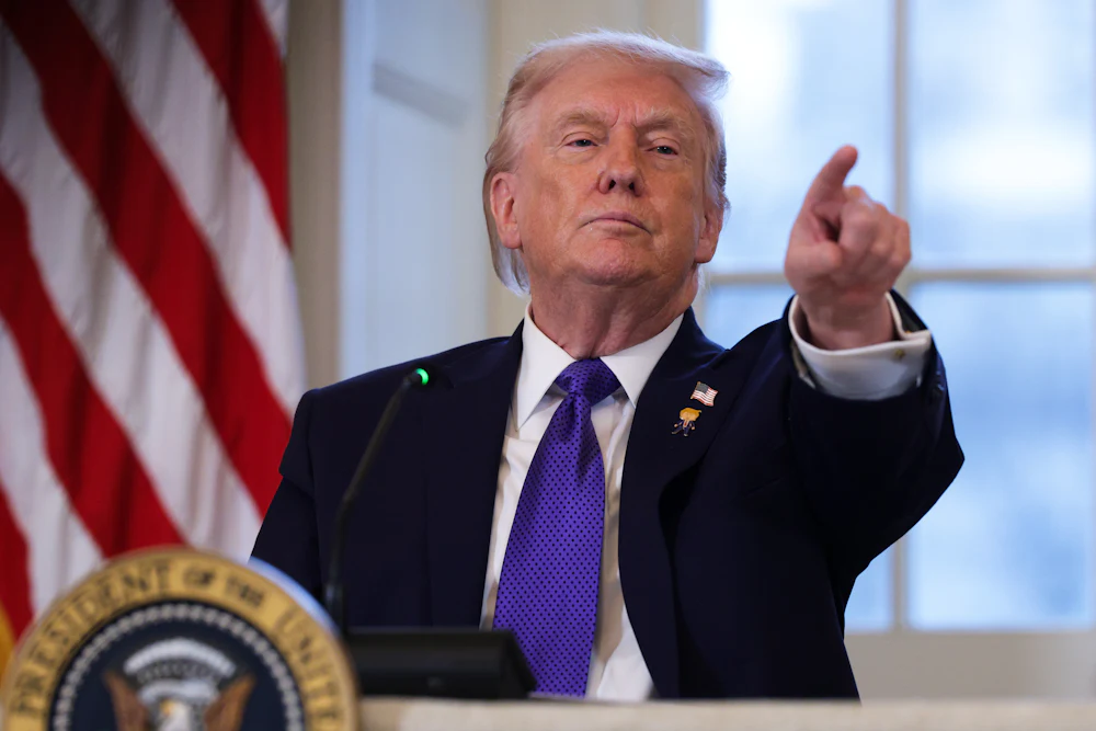 Donald Trump takes questions from members of the media during a meeting with oil and gas executives in the East Room of the White House.