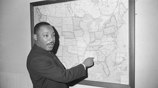 Dr. Martin Luther King points to Selma, Alabama, on a map