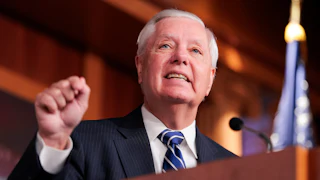 Senator Lindsey Graham gestures while speaking at a podium