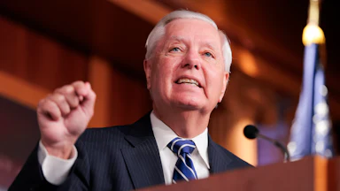 Senator Lindsey Graham gestures while speaking at a podium