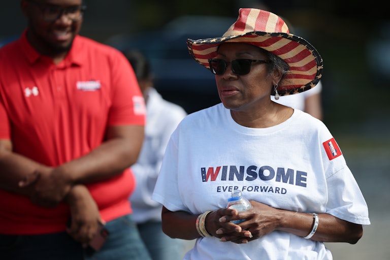 Winsome Earle-Sears wears an American flag cowboy hat and sunglasses, as well as a campaign t-shirt.