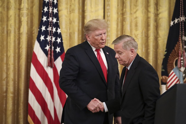 Donald Trump and Lindsey Graham shake hands in the White Houe