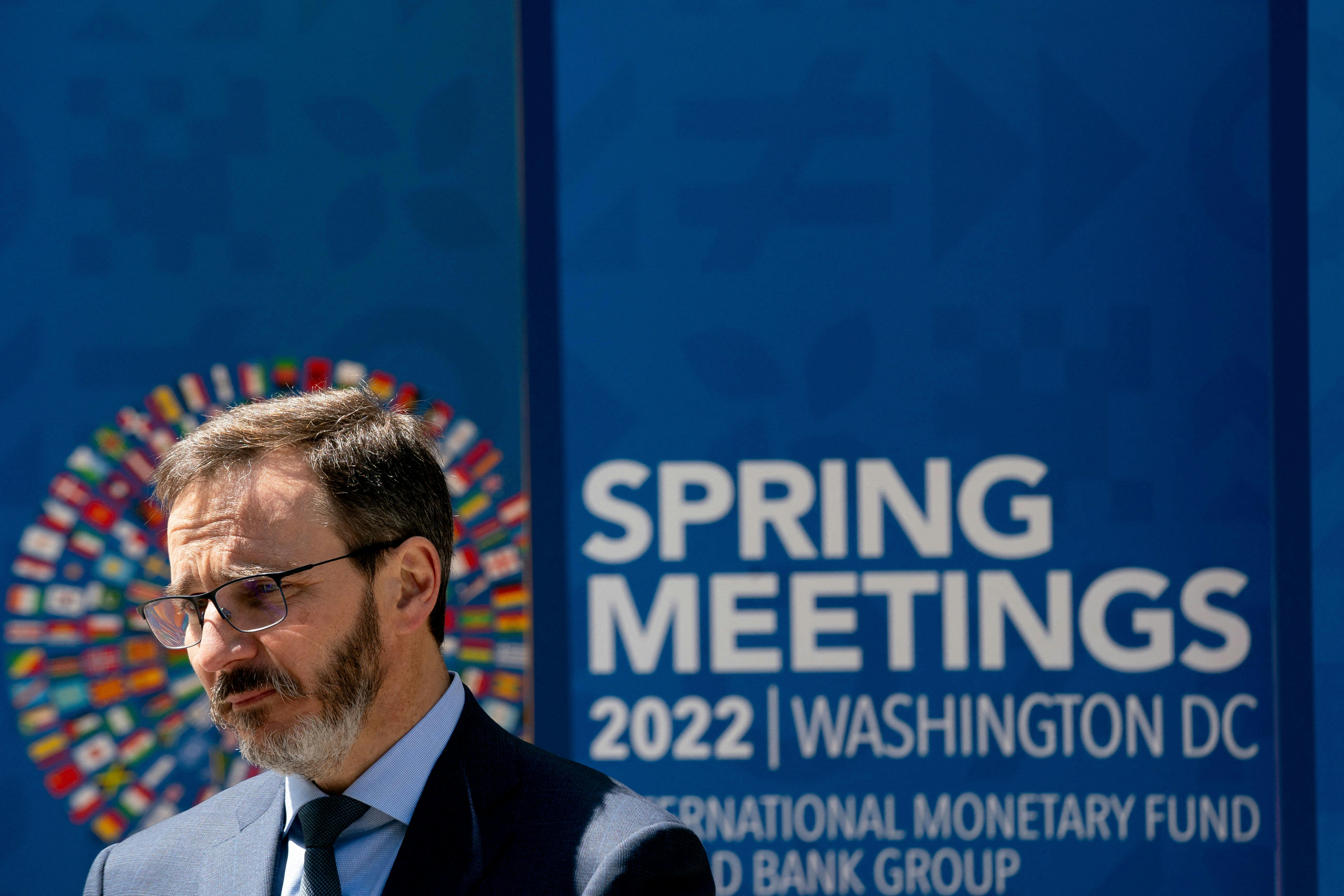 The IMF's new chief economist Pierre-Olivier Gourinchas speaks in front of a banner announcing the IMF's annual meeting.