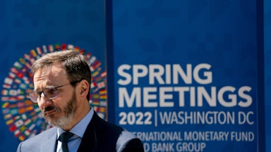 The IMF's new chief economist Pierre-Olivier Gourinchas speaks in front of a banner announcing the IMF's annual meeting.