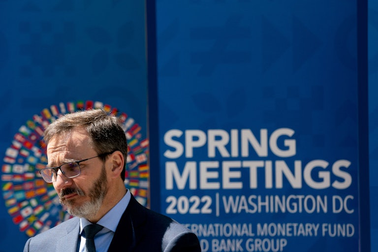 The IMF's new chief economist Pierre-Olivier Gourinchas speaks in front of a banner announcing the IMF's annual meeting.