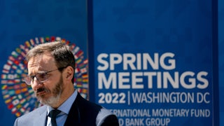 The IMF's new chief economist Pierre-Olivier Gourinchas speaks in front of a banner announcing the IMF's annual meeting.