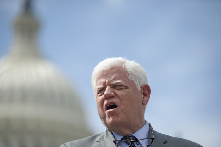 Representative John Larson speaks while standing in front of the Capitol