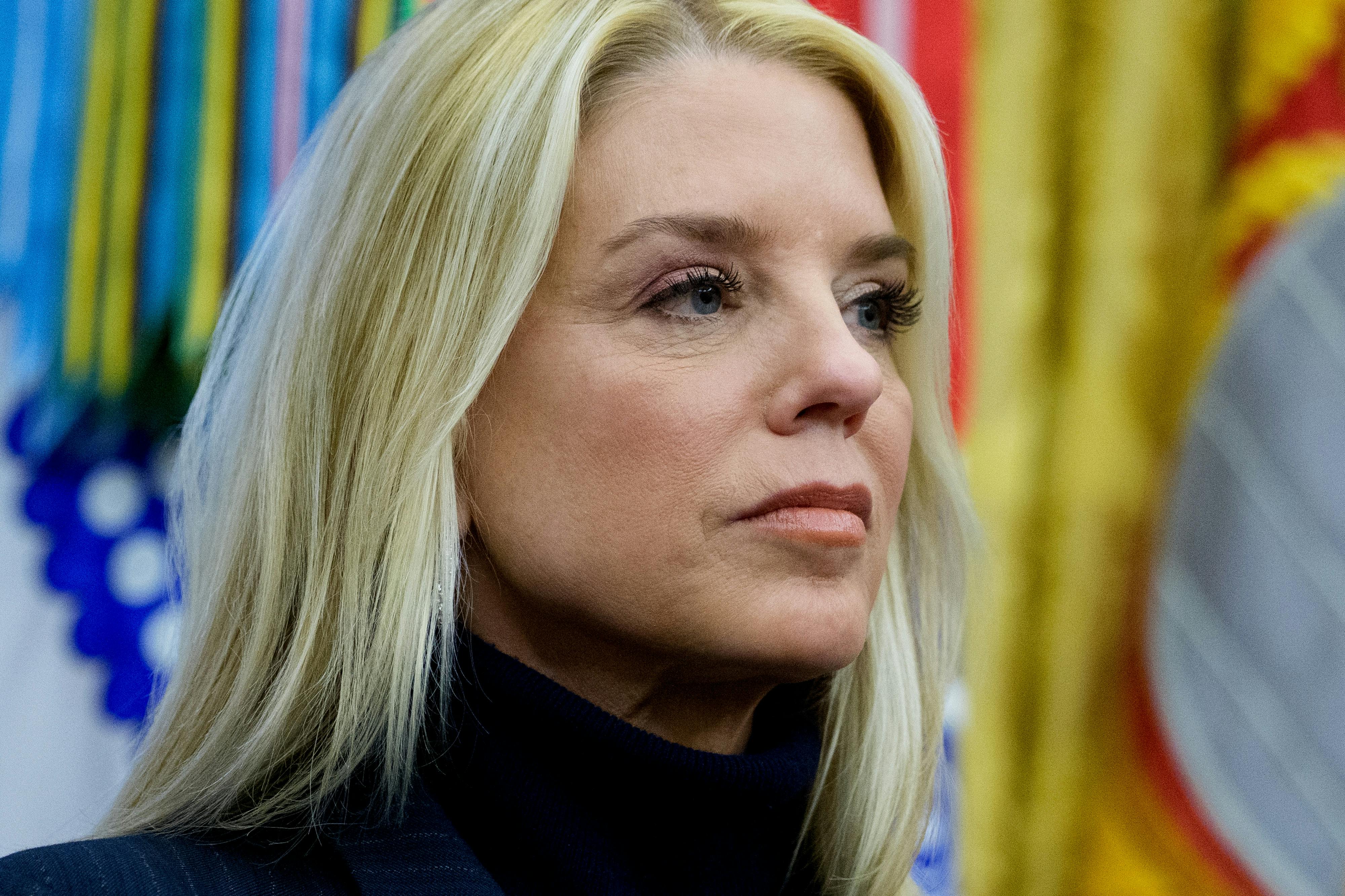 Attorney General Pam Bondi stares off into the distance.