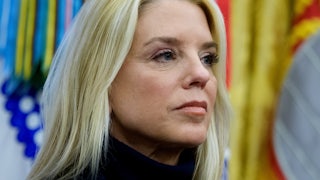 Attorney General Pam Bondi stares off into the distance.