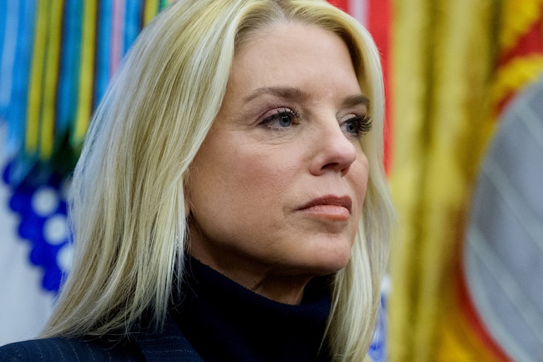 Attorney General Pam Bondi stares off into the distance.