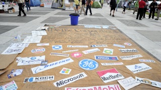 Corporation signs on a mock Preamble to the US Constitution is seen at an Occupy DC camp in Freedom Plaza in Washington, D.C.