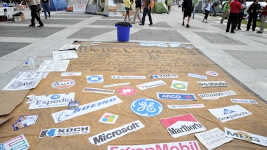 Corporation signs on a mock Preamble to the US Constitution is seen at an Occupy DC camp in Freedom Plaza in Washington, D.C.