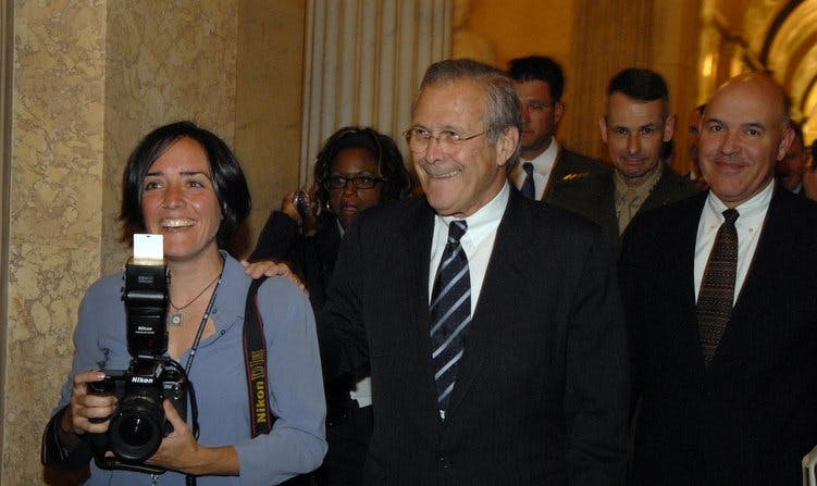 A masterful photobomb is carried out behind Donald Rumsfeld's right shoulder. (Tom Williams)