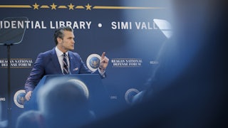 Pete Hegseth speaks at a podium.