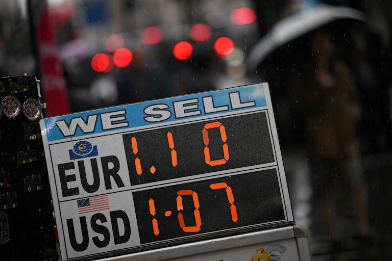A board displaying the price of Euros and U.S. dollars against British pounds 