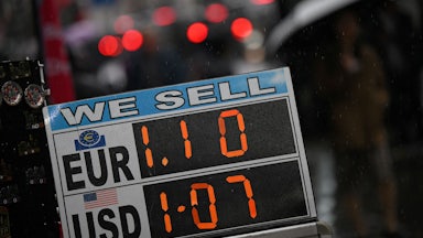 A board displaying the price of Euros and U.S. dollars against British pounds