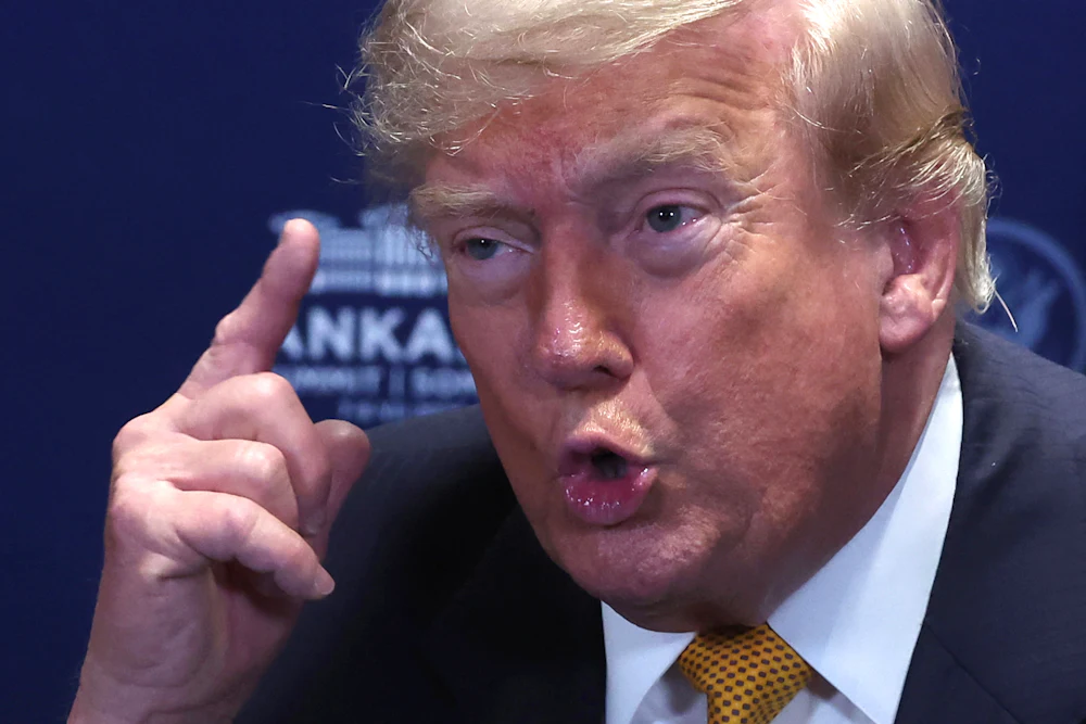 Donald Trump holds up a finger while speaking